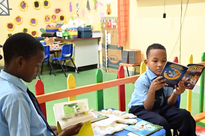 Boys enjoy reading in their Reading Corner at Castle Bruce Primary School, Dominica. Credit: Hannel Jackson